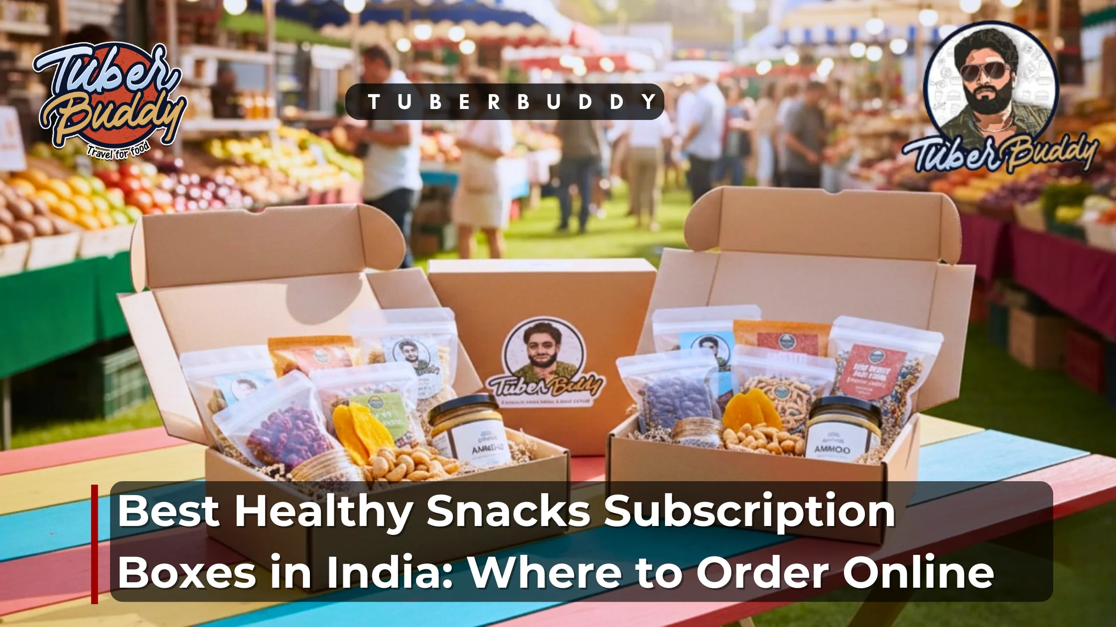 A colorful outdoor market setting featuring open cardboard subscription boxes filled with healthy Indian snacks like nuts, dried fruits, and seeds, branded with the Tuber Buddy logo.
